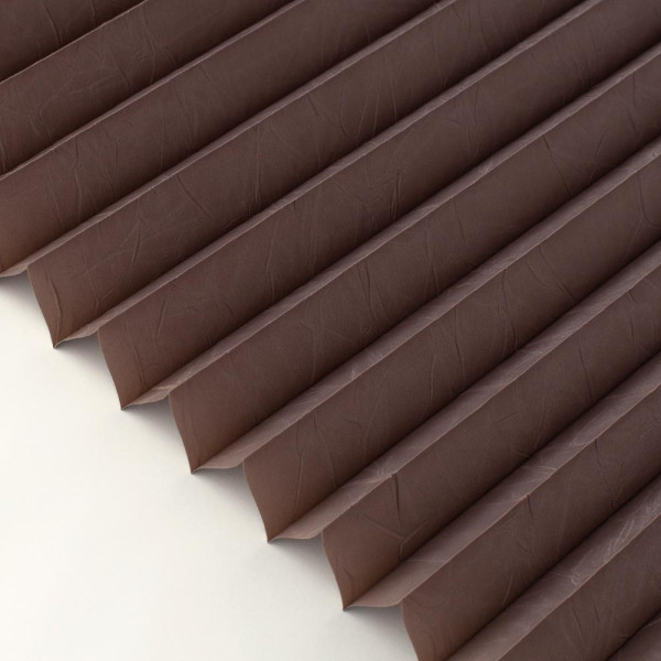 Braunes Plissee in vertikalen Falten, das auf einem weißen Hintergrund liegt. Es zeigt die Struktur und Textur des Materials. Ideal für Sichtschutz und dekorative Zwecke.